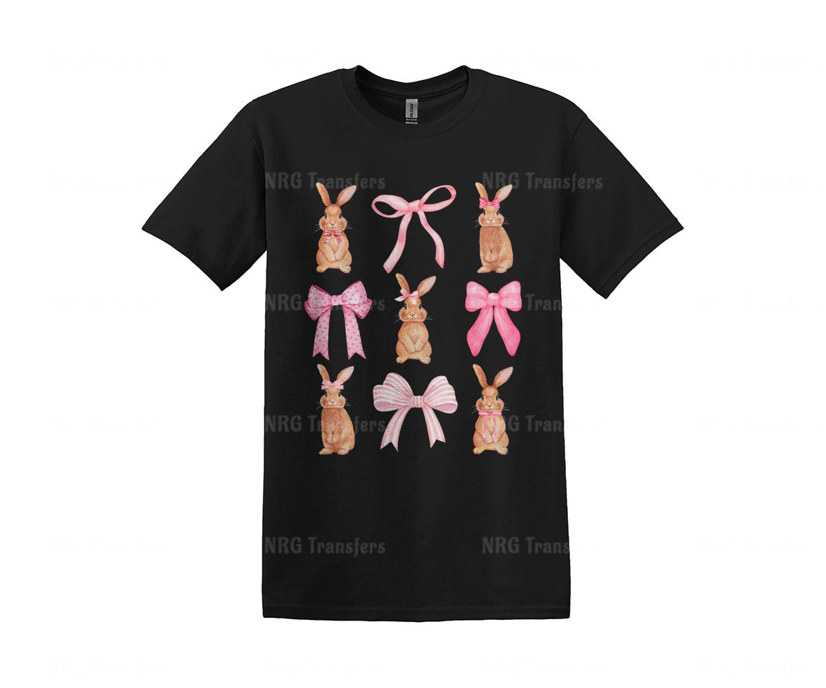 a black t - shirt with pink bows and rabbits on it