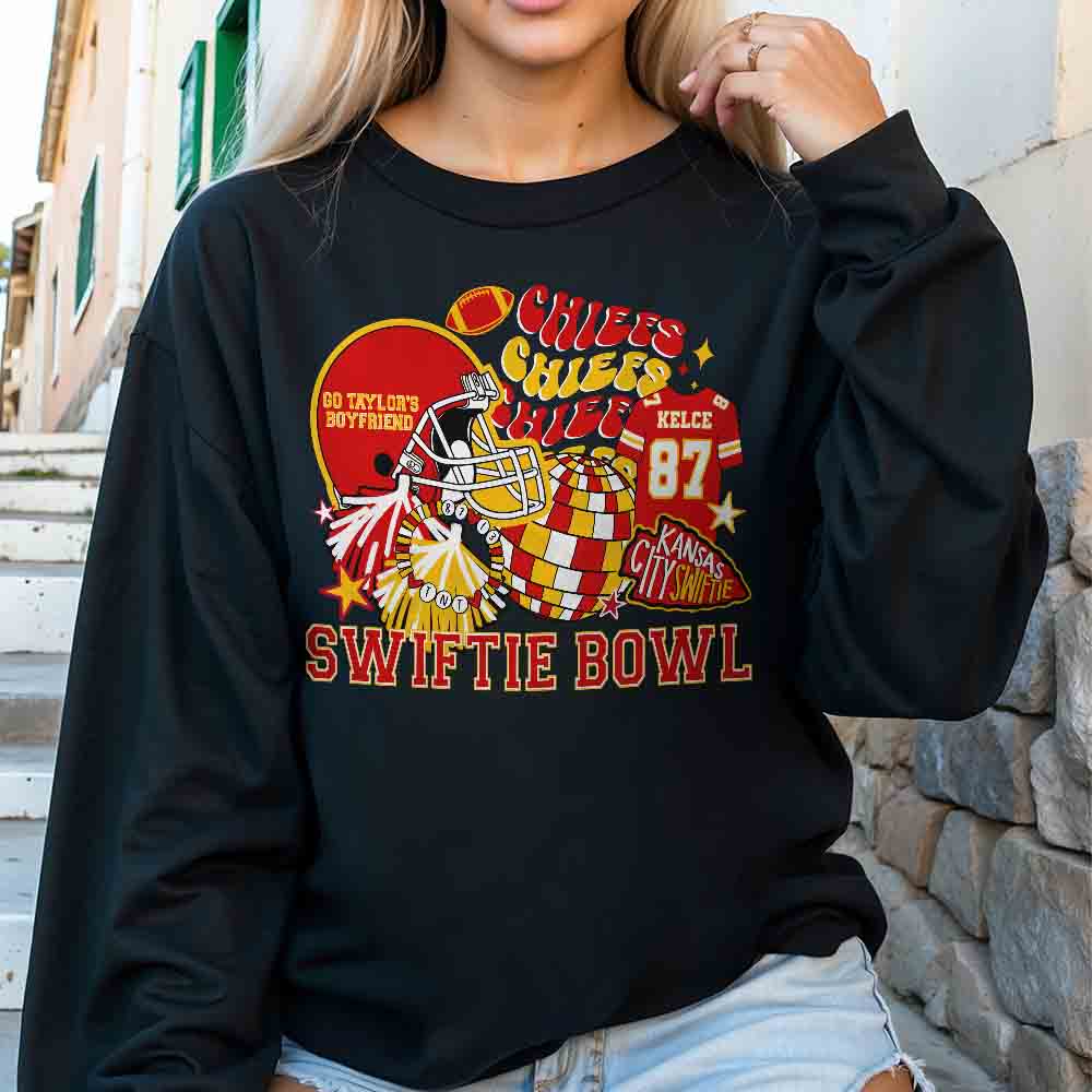 a woman wearing a black sweatshirt with a picture of a clown on it