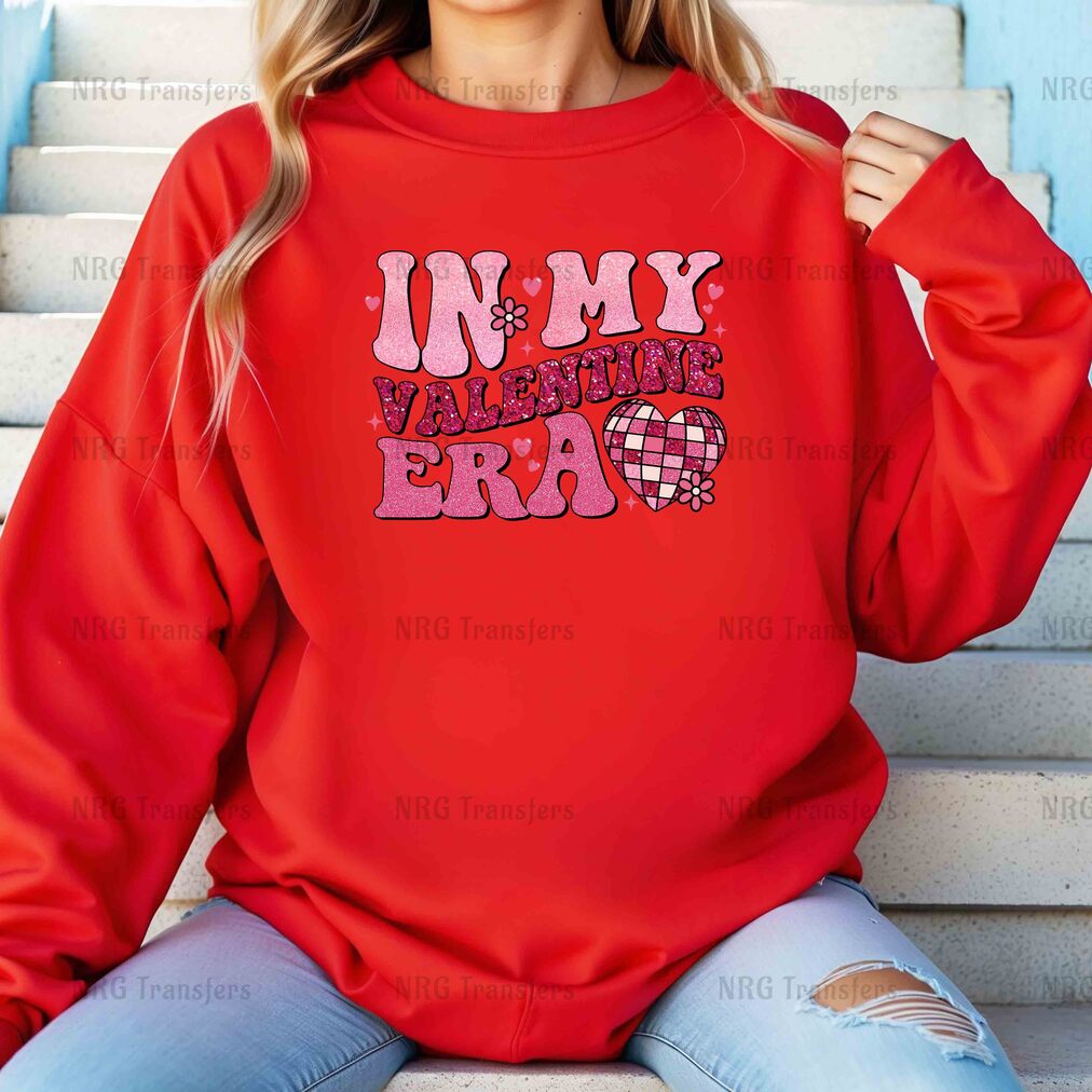 a woman wearing a red sweatshirt that says in my valentine's era