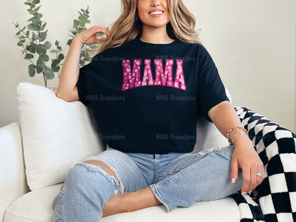 a woman sitting on a couch wearing a mama shirt