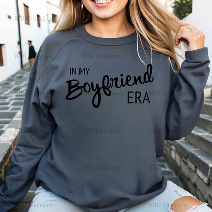 a woman wearing a sweatshirt that says in my boyfriend era