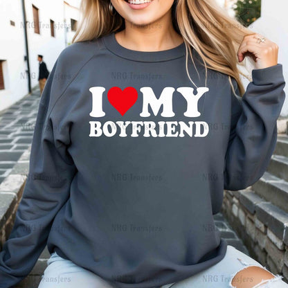 a woman wearing a sweatshirt that says i love my boyfriend