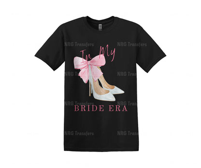 a black t - shirt with a pink bow on it