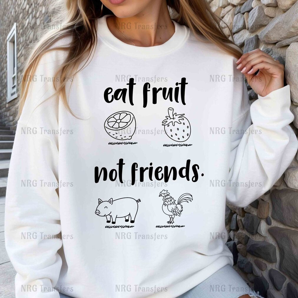 a woman wearing a sweatshirt that says eat fruit not friends