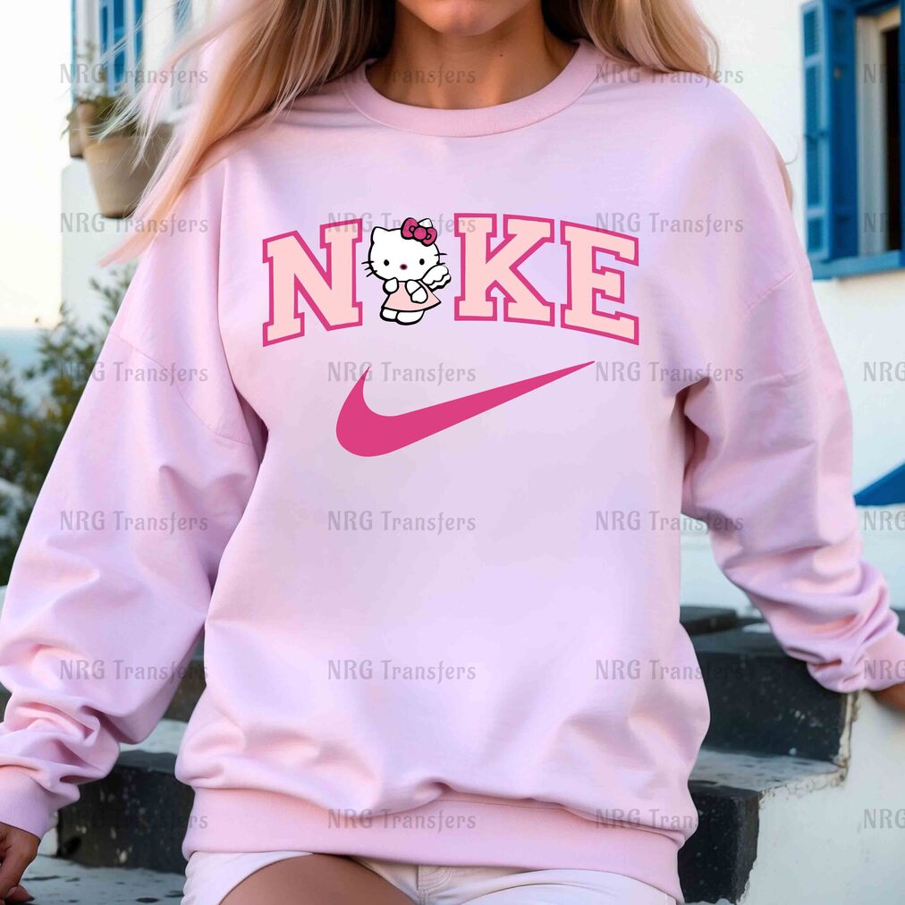 a woman wearing a pink sweatshirt with a hello kitty on it