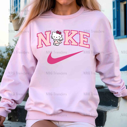 a woman wearing a pink sweatshirt with a hello kitty on it