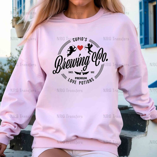 a woman wearing a pink crew neck sweatshirt